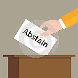 Abstain choice vote hand putting a ballot paper in a slot of box photo