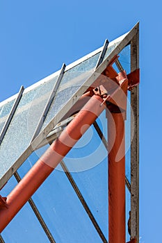 Abstract achitecture. Modern design apex with red tubing against photo