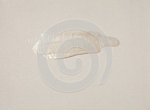 Abstract acrylic smear brushstroke blot painting on canvas wall. Beige nacre color copy space texture horizontal background photo