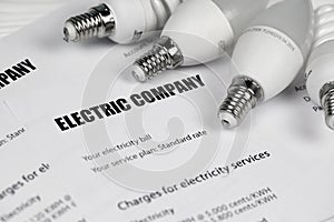 Abstract American electricity bill. Concept of saving money by using energy savings led light bulbs and electric bill payment