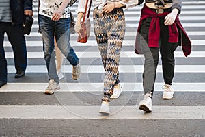 Abstract anonymous people walking on zebra crossing city street