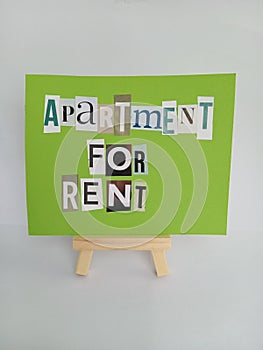 Abstract apartment for rent sign on a wood easel on a white background