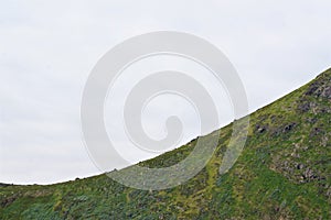 Abstract arc shape of mossy mountain summit