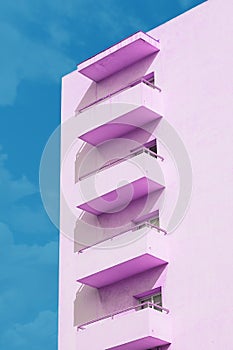 Abstract architecture background. Pink geometry against blue sky. Empty copy space