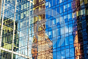 Sky and buildings are reflected in the office skyscraper facade