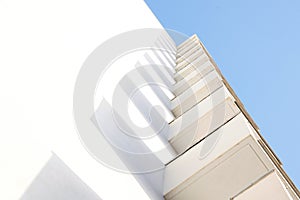 Abstract architecture background. White geometry against blue sky.