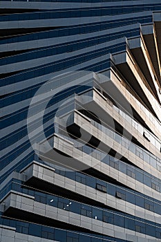 Abstract architecture, modern glass building. Close up view of a spiral modern office building at dusk