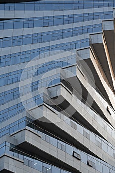 Abstract architecture, modern glass building. Close up view of a spiral modern office building at dusk