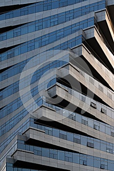 Abstract architecture, modern glass building. Close up view of a spiral modern office building at dusk