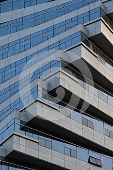 Abstract architecture, modern glass building. Close up view of a spiral modern office building at dusk