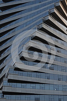 Abstract architecture, modern glass building. Close up view of a spiral modern office building at dusk