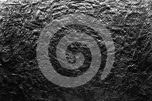 Black and white plasticine texture on a modeling board