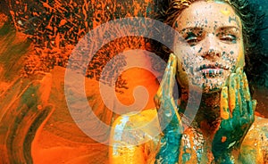 abstract art bodypainting of fantastic portrait of a sexy young brunette woman  dots of white  blue and orange color  artful photo