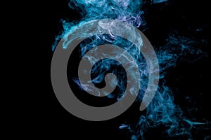 Abstract art colored blue and pink smoke on black isolated background.