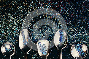 Abstract art concept with multicolored glitter and spoons. Idea of the sky, space, music and subcultures. Background. photo