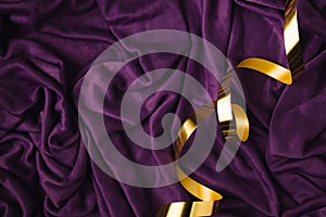 Abstract art concept purple silk or saten backround with golden ribbon. Party of birthday idea with copy space photo