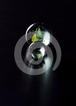 Abstract art image of two glass marbles, one big and one small