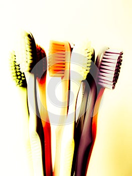 Abstract art photo of a group of toothbrushes of different colors,
