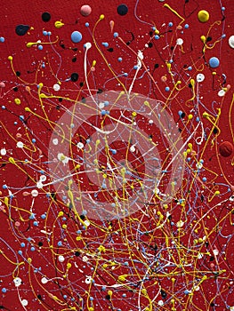 abstract art picture in jackson style pollock color splash on red background