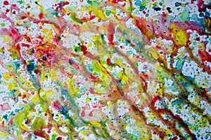 Abstract art of vivid bright colorful watercolor splash and drops on the white paper