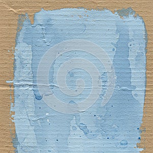 Abstract artwork featuring a textured cardboard surface with a central, unevenly