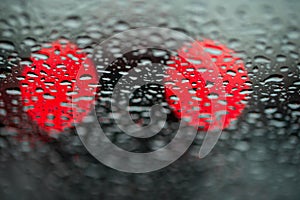 Abstract background for the banner. Two night lights of city transport were seen through the windshield in rainy weather