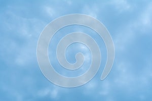 Abstract background based on clouds of uncertain shape in light blue sky