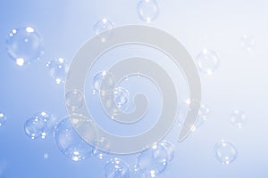 Abstract Background. Beautiful Transparent Soap Bubbles Floating on Blue Background.