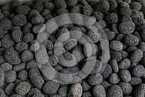 Abstract background of black pebble stones on the floor.