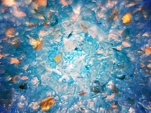 Abstract background of blue sand with sparkles in soft focus.
