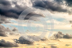 Abstract background, blue sky with dark cumulonimbus clouds.