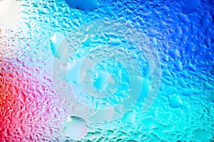 Abstract background. Abstract blur image of colored soft spots of gradients and glare through wet glass. Texture of water drops on