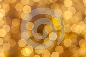 Abstract background blurred yellow golden bokeh circles.