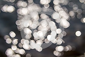 Abstract background with bokeh sun lights in the lake.