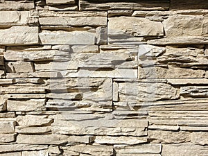 Abstract background . Brown stone wall close up. Folded stone wall background horizontal. Facing with a stone wall