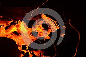 Abstract background, burning coals, fire and sparks on a black background