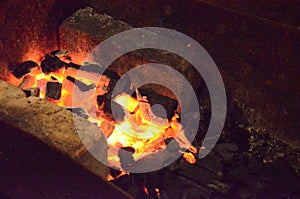 Abstract background, burning coals, fire and sparks on a black background