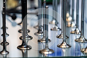 Abstract background with car engine valves in a glass showcase, closeup