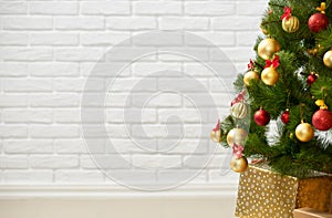 Abstract background from christmas tree and blank brick wall, classic white interior backdrop, copy space for text, winter holiday