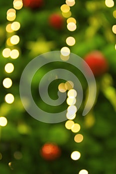 Abstract background with christmas tree with decorations, defocused bokeh lights