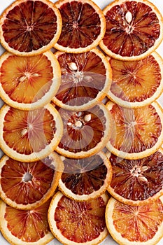 Abstract background with citrus fruit of orange slices. Pattern of orange red citruses. Close-up