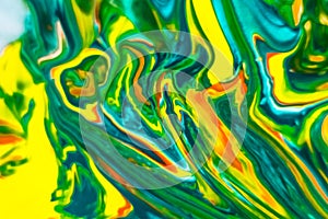 Abstract background of colored paint mixing in water, close-up.