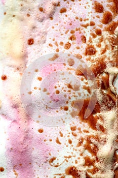 Abstract background of colorful drops of melted ice cream on paper wrapping paper.