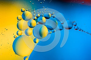 Abstract background with colorful gradient colors. Oil drops in water abstract psychedelic pattern image. Blue yellow yellow color