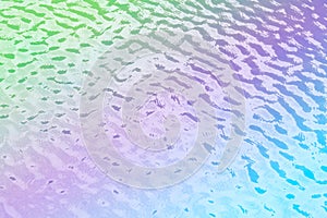 Abstract background of colorful ripples on water.