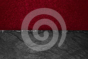 Abstract background composition of divided in the half matt vivid burgundy color paper and black stone with copy space