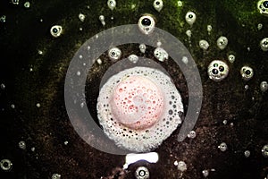 abstract background created with bubbles of various sizes on a dark background creating a similarity with galaxies.