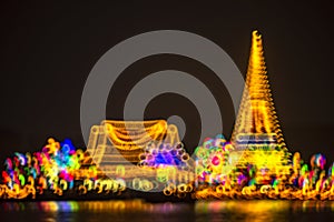 Abstract background with defocused bokeh of night festival in Prasamut Chedi Temple.