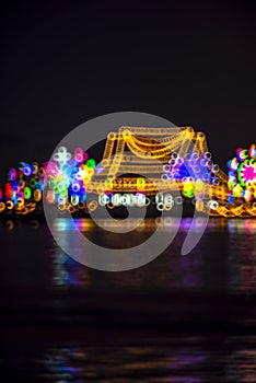 Abstract background with defocused bokeh of night festival in Prasamut Chedi Temple.