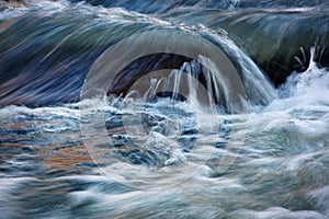 Detail the autumn blurred water rapids